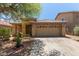 Inviting single-story home featuring a neutral stucco finish, tile roof, desert landscaping, and an attached two-car garage at 2421 W Romley Rd, Phoenix, AZ 85041