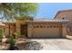 Charming single-story home with a two-car garage, a tile roof, desert landscaping, and security system at 2421 W Romley Rd, Phoenix, AZ 85041