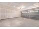 Unfinished garage with drywall, lighting, and garage door at 2421 W Romley Rd, Phoenix, AZ 85041