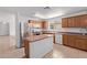 Spacious kitchen with stainless steel refrigerator, island, and wooden cabinets at 2421 W Romley Rd, Phoenix, AZ 85041