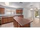 Bright kitchen features an island, light wood cabinets, and access to living area at 2421 W Romley Rd, Phoenix, AZ 85041