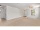 Spacious living room features neutral carpet and tile flooring, ceiling fan and great natural light from a large window at 2421 W Romley Rd, Phoenix, AZ 85041