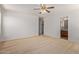 Spacious main bedroom with ceiling fan and open view to the ensuite bathroom at 2421 W Romley Rd, Phoenix, AZ 85041
