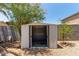 Backyard metal shed with open doors, gravel surround and small yard at 2421 W Romley Rd, Phoenix, AZ 85041