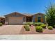 Charming single-story home featuring a desert landscaped front yard, two car garage, and colorful flower bushes at 31324 N 26 Glen Gln, Phoenix, AZ 85085