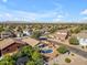 Wide aerial shot showcases a neighborhood with lush greenery and a home with a sparkling pool, perfect for relaxation at 3373 W Five Mile Peak Dr, San Tan Valley, AZ 85144