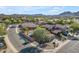 Aerial view of a home, highlighting the pool and desert landscaping, in a neighborhood with mountain views at 3373 W Five Mile Peak Dr, San Tan Valley, AZ 85144