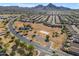 Stunning aerial view of a neighborhood with a park, backed by scenic mountains, showcasing community and nature at 3373 W Five Mile Peak Dr, San Tan Valley, AZ 85144