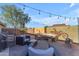 Back patio featuring outdoor sofa seating, lighting, art on wall and a firepit at 3373 W Five Mile Peak Dr, San Tan Valley, AZ 85144