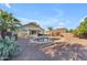 Backyard with pool, seating, grass and desert landscaping, and a desert style house at 3373 W Five Mile Peak Dr, San Tan Valley, AZ 85144