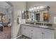 Stylishly designed bathroom features a double vanity, large mirror, and access to the main bedroom at 3373 W Five Mile Peak Dr, San Tan Valley, AZ 85144