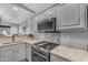 Well-appointed kitchen with stainless steel appliances, gray backsplash, and stone countertops at 3373 W Five Mile Peak Dr, San Tan Valley, AZ 85144