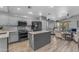 Open-concept kitchen with modern appliances, granite countertops, and an island open to living area at 3373 W Five Mile Peak Dr, San Tan Valley, AZ 85144