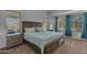 Comfortable main bedroom features a wooden bed frame, plentiful natural light, and soft, neutral tones at 3373 W Five Mile Peak Dr, San Tan Valley, AZ 85144