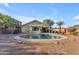 A refreshing backyard pool is surrounded by desert landscaping and lush palm trees, perfect for relaxing and enjoying the Arizona sun at 3373 W Five Mile Peak Dr, San Tan Valley, AZ 85144