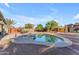 Backyard pool with surrounding desert landscaping, nearby patio, and clear blue sky at 3373 W Five Mile Peak Dr, San Tan Valley, AZ 85144