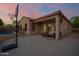 An inviting covered patio features comfortable seating, a basketball hoop, and a refreshing pool in the background at 3438 W Little Hopi Dr, Phoenix, AZ 85086