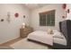Cozy bedroom with soft carpet, comfy bed, side table with lamp, and window at 3438 W Little Hopi Dr, Phoenix, AZ 85086