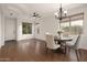 Bright dining room with a chandelier, ample natural light, wood floors, and stylish furnishings at 3438 W Little Hopi Dr, Phoenix, AZ 85086