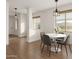 Bright dining room with a modern light fixture, wood floors, and stylish furnishings at 3438 W Little Hopi Dr, Phoenix, AZ 85086