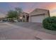 Charming single-story home showcasing a manicured front yard, desert landscaping, and a spacious two-car garage at 3438 W Little Hopi Dr, Phoenix, AZ 85086