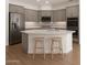 Modern kitchen featuring stainless steel appliances, a center island with bar stools, and hardwood floors at 3438 W Little Hopi Dr, Phoenix, AZ 85086