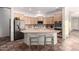 Charming kitchen featuring stainless steel appliances, a center island with bar stools, and tile floors at 3438 W Little Hopi Dr, Phoenix, AZ 85086