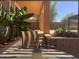 Backyard featuring lush landscaping, covered patio, and an outdoor dining area at 35743 W Cartegna Ln, Maricopa, AZ 85138