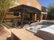 Backyard patio with a covered pergola, outdoor seating, a pool, and a hot tub at 35743 W Cartegna Ln, Maricopa, AZ 85138