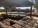Relaxing backyard pool area with a pergola, built in barbeque, bar and plenty of seating at 35743 W Cartegna Ln, Maricopa, AZ 85138