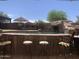 Backyard pool area featuring a bar, grill, water feature and ample room for seating and relaxing at 35743 W Cartegna Ln, Maricopa, AZ 85138