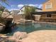 Inviting backyard pool with a rock feature and a hot tub, perfect for outdoor enjoyment at 35743 W Cartegna Ln, Maricopa, AZ 85138