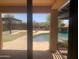 View of a pool and backyard with a rock waterfall and slide from the home's interior at 35743 W Cartegna Ln, Maricopa, AZ 85138