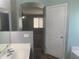 Bathroom with open door and archway leading to a carpeted room with natural light at 35743 W Cartegna Ln, Maricopa, AZ 85138