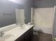 Bathroom featuring double sink vanity, bathtub and shower combo at 35743 W Cartegna Ln, Maricopa, AZ 85138