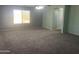 Bright, carpeted bedroom with a ceiling fan and large windows allowing ample sunlight at 35743 W Cartegna Ln, Maricopa, AZ 85138