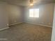 Spacious bedroom featuring a ceiling fan, carpeted floors and bright natural lighting at 35743 W Cartegna Ln, Maricopa, AZ 85138