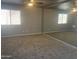 Bedroom with carpet and light walls, featuring a large wall mirror reflecting the space at 35743 W Cartegna Ln, Maricopa, AZ 85138