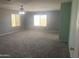 Spacious bedroom with neutral carpet, multiple windows, and ample natural light at 35743 W Cartegna Ln, Maricopa, AZ 85138