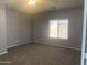 Unfurnished bedroom with neutral paint, carpet, and natural light from a window at 35743 W Cartegna Ln, Maricopa, AZ 85138