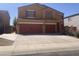 Two-story home with a large concrete driveway at 35743 W Cartegna Ln, Maricopa, AZ 85138