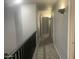 Hallway with carpet, sconces, and neutral paint at 35743 W Cartegna Ln, Maricopa, AZ 85138