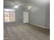 Inviting living room with carpet, tile entryway, ample natural light, and a neutral color palette at 35743 W Cartegna Ln, Maricopa, AZ 85138