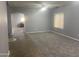 Bright living room featuring plush carpet, neutral paint, and an arched doorway for easy access at 35743 W Cartegna Ln, Maricopa, AZ 85138
