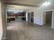 Open-concept living space with kitchen, gray walls, brown cabinets, and tile flooring at 35743 W Cartegna Ln, Maricopa, AZ 85138