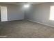 Neutral carpet, fan, and windows in this spacious bedroom at 35743 W Cartegna Ln, Maricopa, AZ 85138
