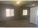 Spacious main bedroom featuring neutral gray walls, carpeted floors, and a large mirror accent wall at 35743 W Cartegna Ln, Maricopa, AZ 85138