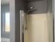 Shower with glass door and modern showerhead at 35743 W Cartegna Ln, Maricopa, AZ 85138
