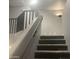 Staircase showcasing carpeted steps and a decorative wall fixture at 35743 W Cartegna Ln, Maricopa, AZ 85138