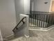 Carpeted stairs with dark railing and white walls, providing a modern aesthetic at 35743 W Cartegna Ln, Maricopa, AZ 85138